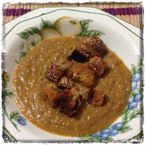 Crema de lentejas servida con picatostes de pan.